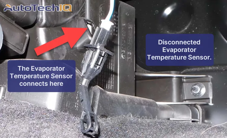 A disconnected evaporator temperature sensor under the dashboard. It can be manually connected in a specific place